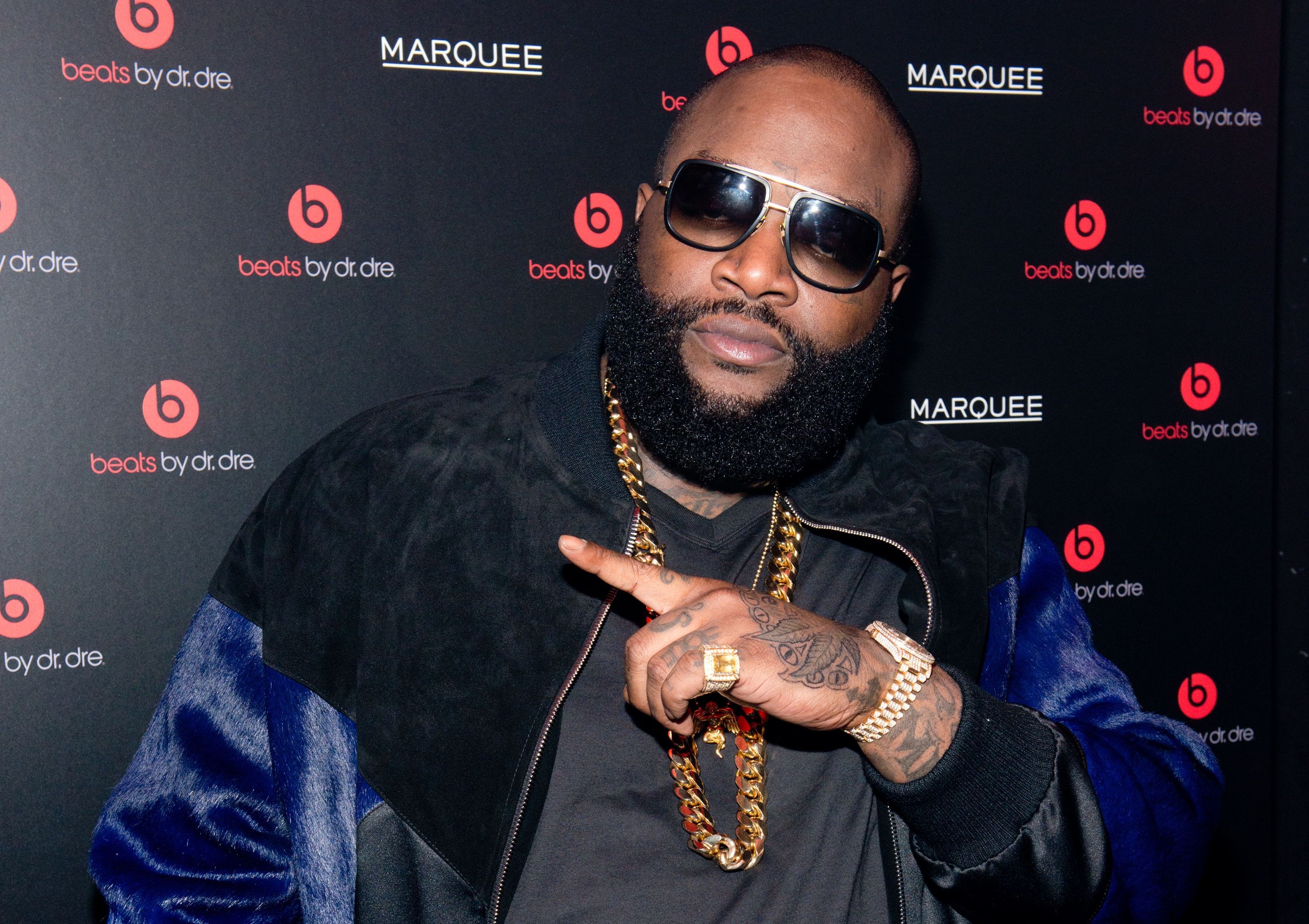rick ross pointing sunglasses beats by dre event