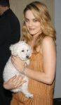 Alicia Silverstone posing with her furry pup.