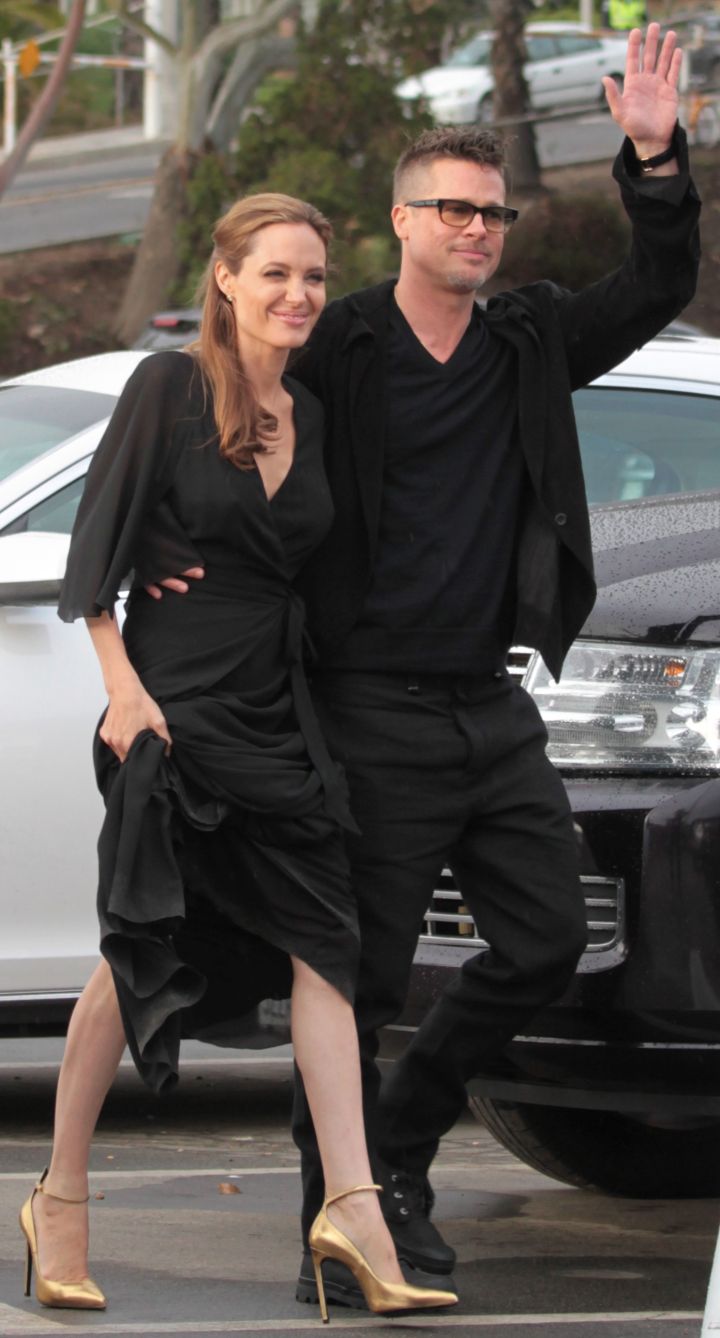 Brad holds onto his woman tight.