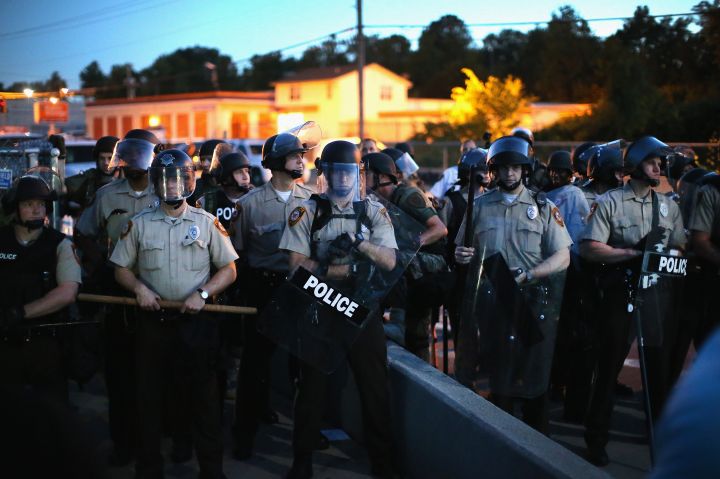 A real life S.W.A.T. team staring down unarmed civilians and reporters.