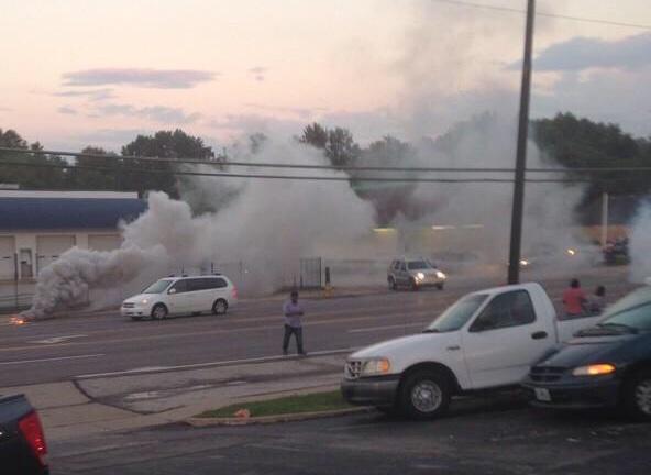 St. Louis resident and reporter on the ground Antonio French stands in the middle of a cloud after police fire tear gas into the crowd.