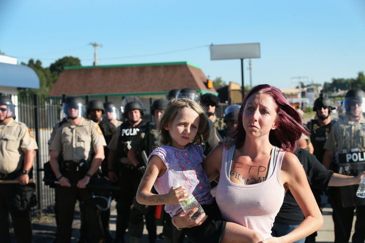 Demonstrator walks away after being ordered off the street by police.