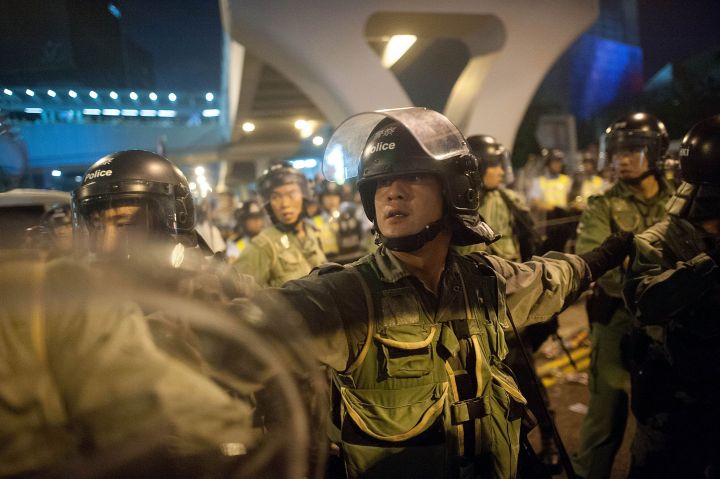 Police and demonstrators clash in the street during Hong Kong’s Umbrella Revolution, spurred by Chinese government’s plans to vet candidates in Hong Kong’s 2017 elections.