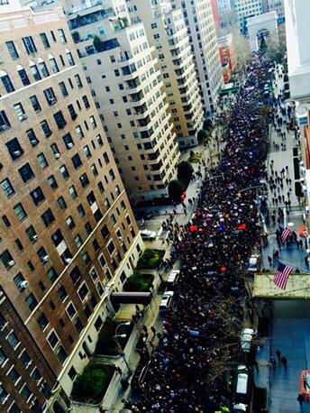 Thousands march up 5th Avenue.