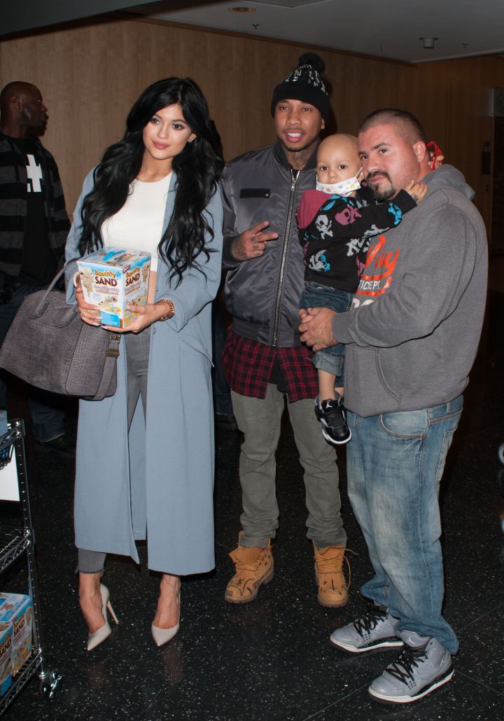 Tyga and Kylie pose with fans at a children’s hospital.