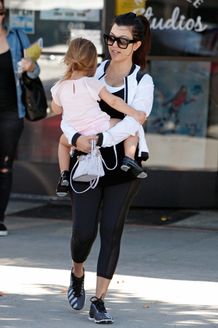 Kourtney often gets put on purse duty.