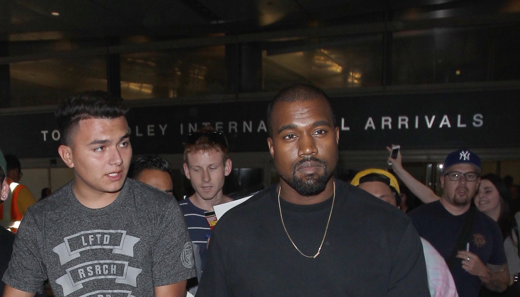 Kanye West is mobbed by autograph collectors as he arrives in Los Angeles