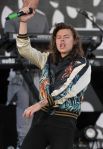 Harry Styles is turnt up in a silk bomber jacket at a recent One Direction concert.