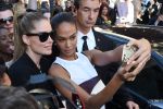 This dude is totally photobombing the selfie Doutzen Kroes and Joan Smalls are trying to take at the Balmain fashion show during Paris Fashion Week.
