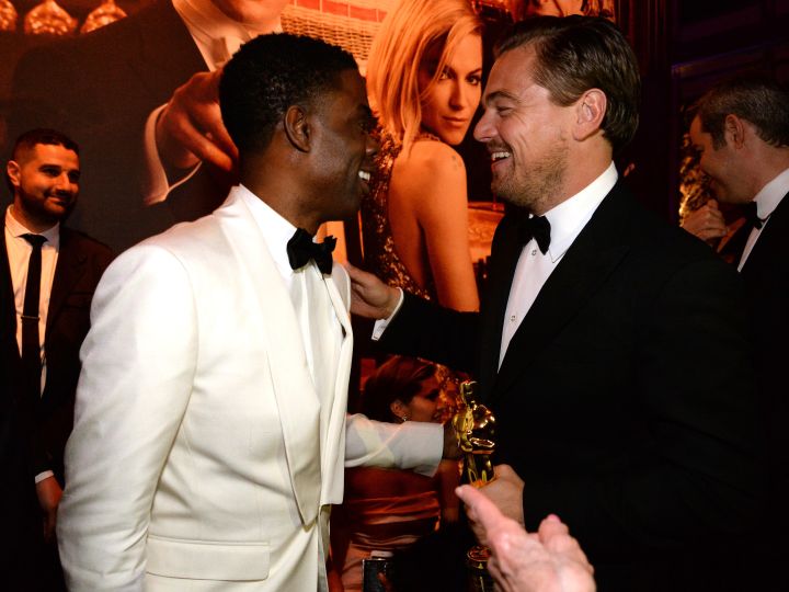 Chris Rock talks with the nightās big winner, Leonardo DiCaprio.