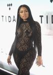Nicki Minaj wears a fishnet bodysuit, black thong, and pasties.