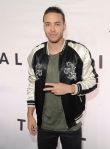 Prince Royce chucks up the deuces.