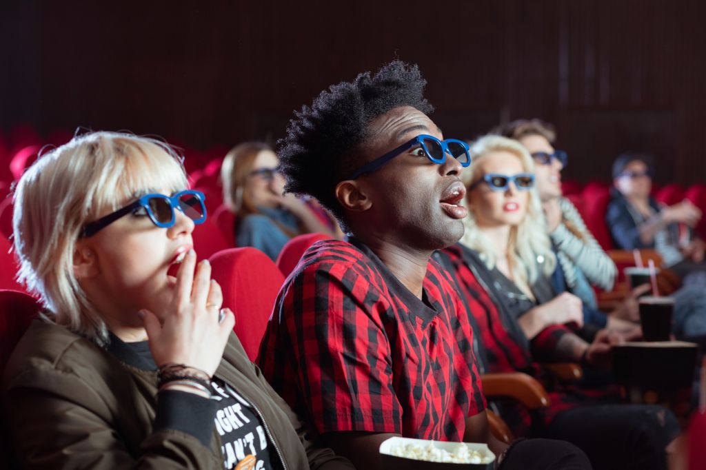 Young people in 3D movie theater