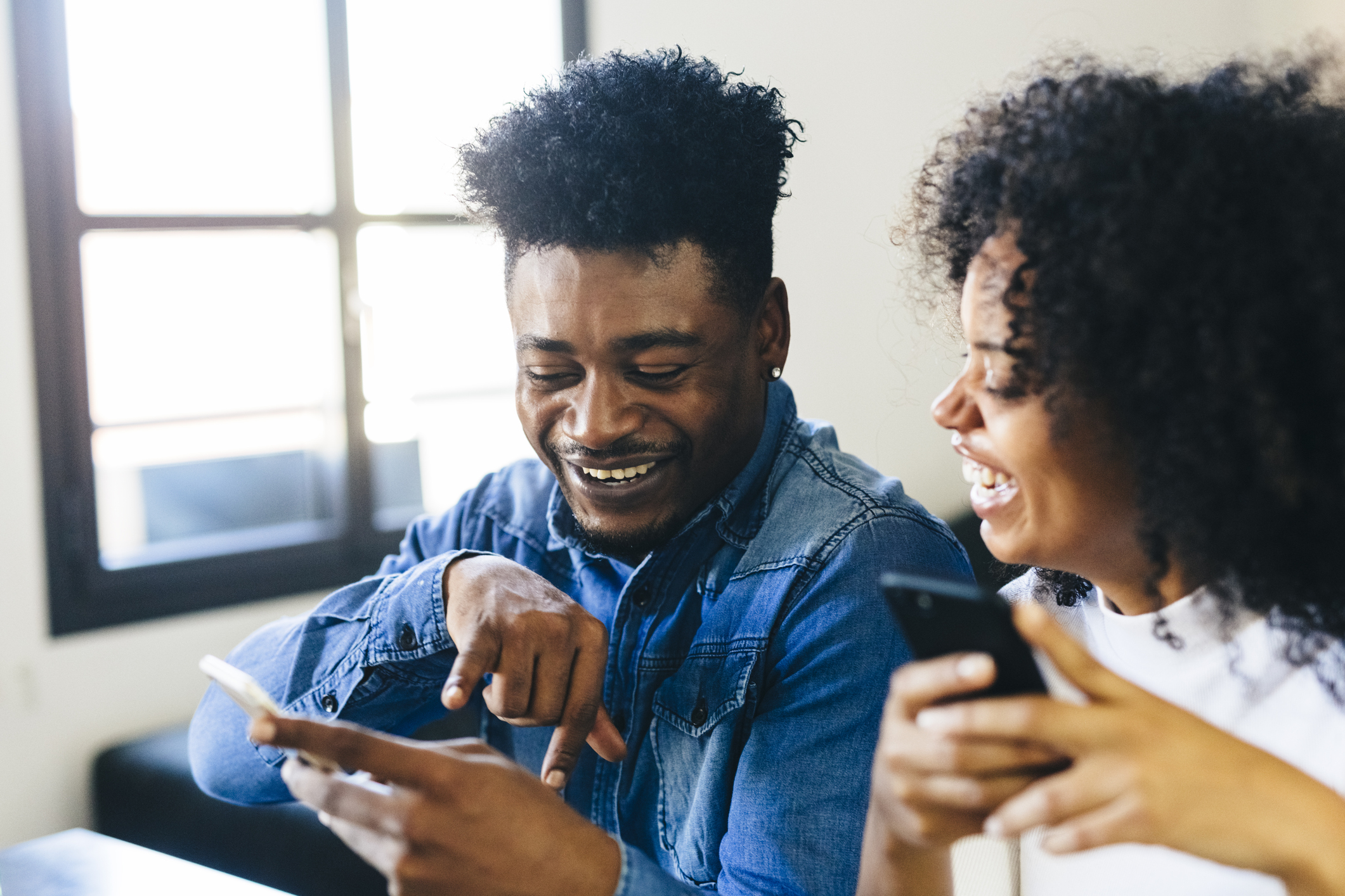 Happy couple looking at cell phone