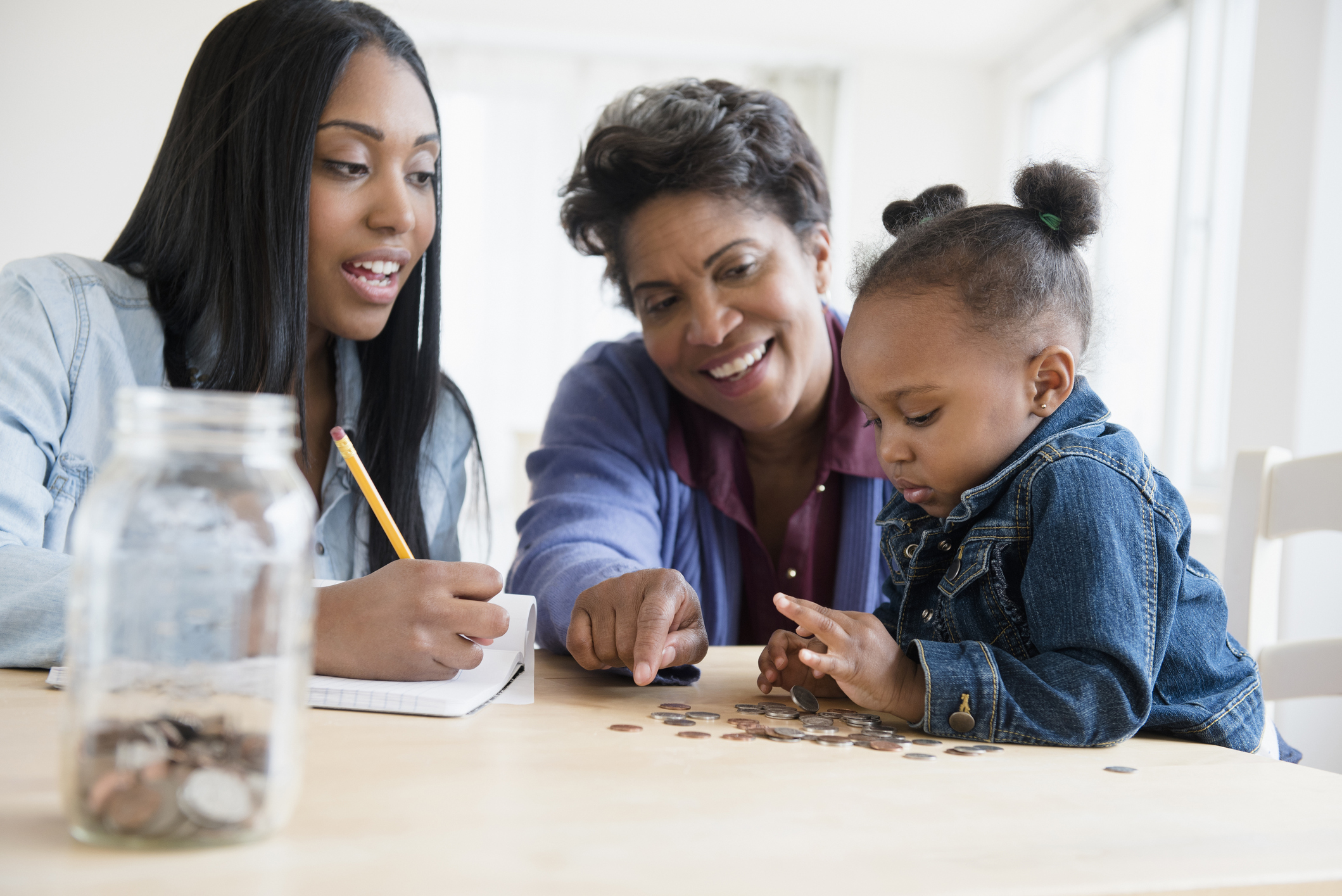Black multi-generation family counting coins