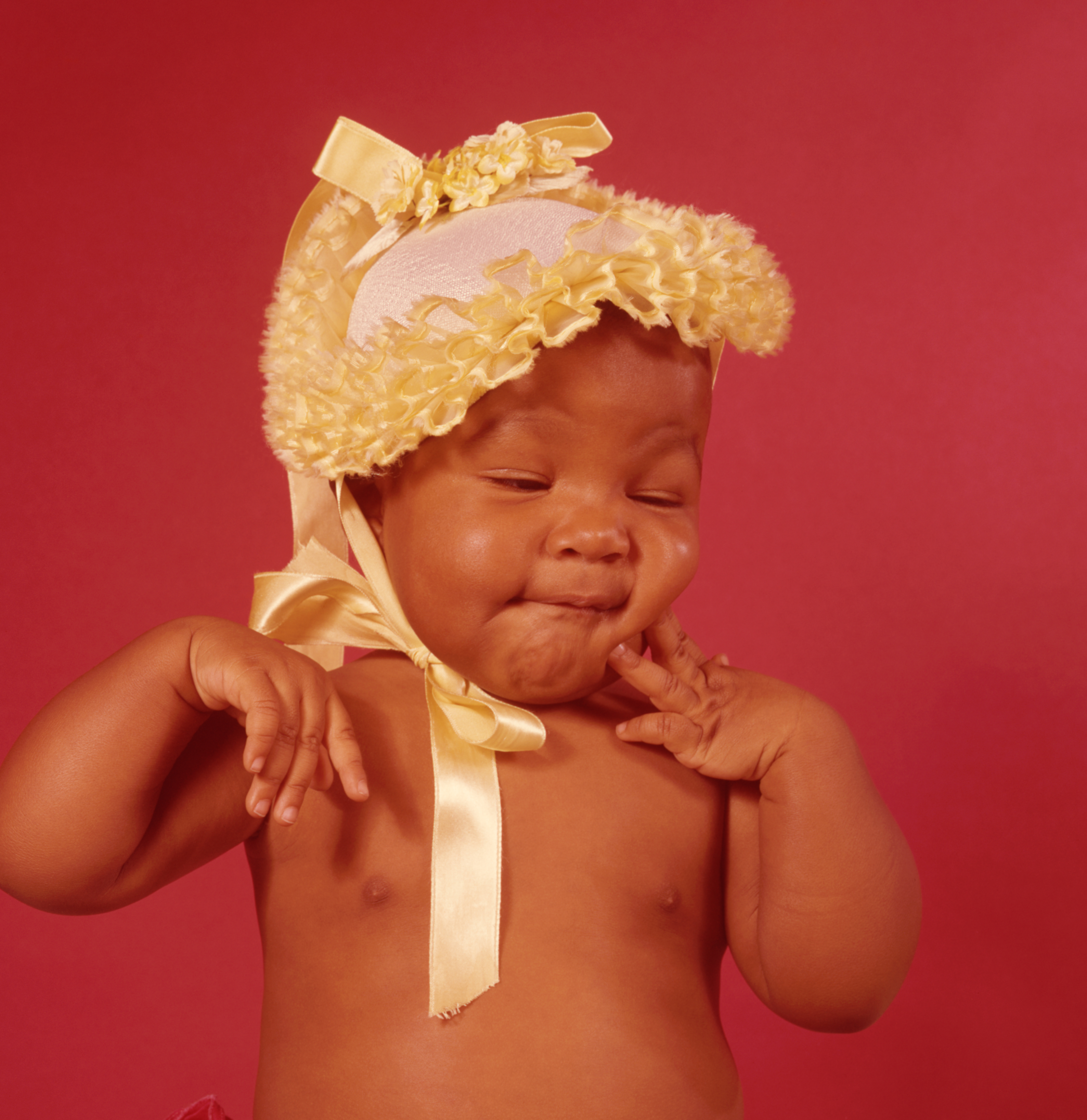 Black Baby Wearing Yellow Bonnet