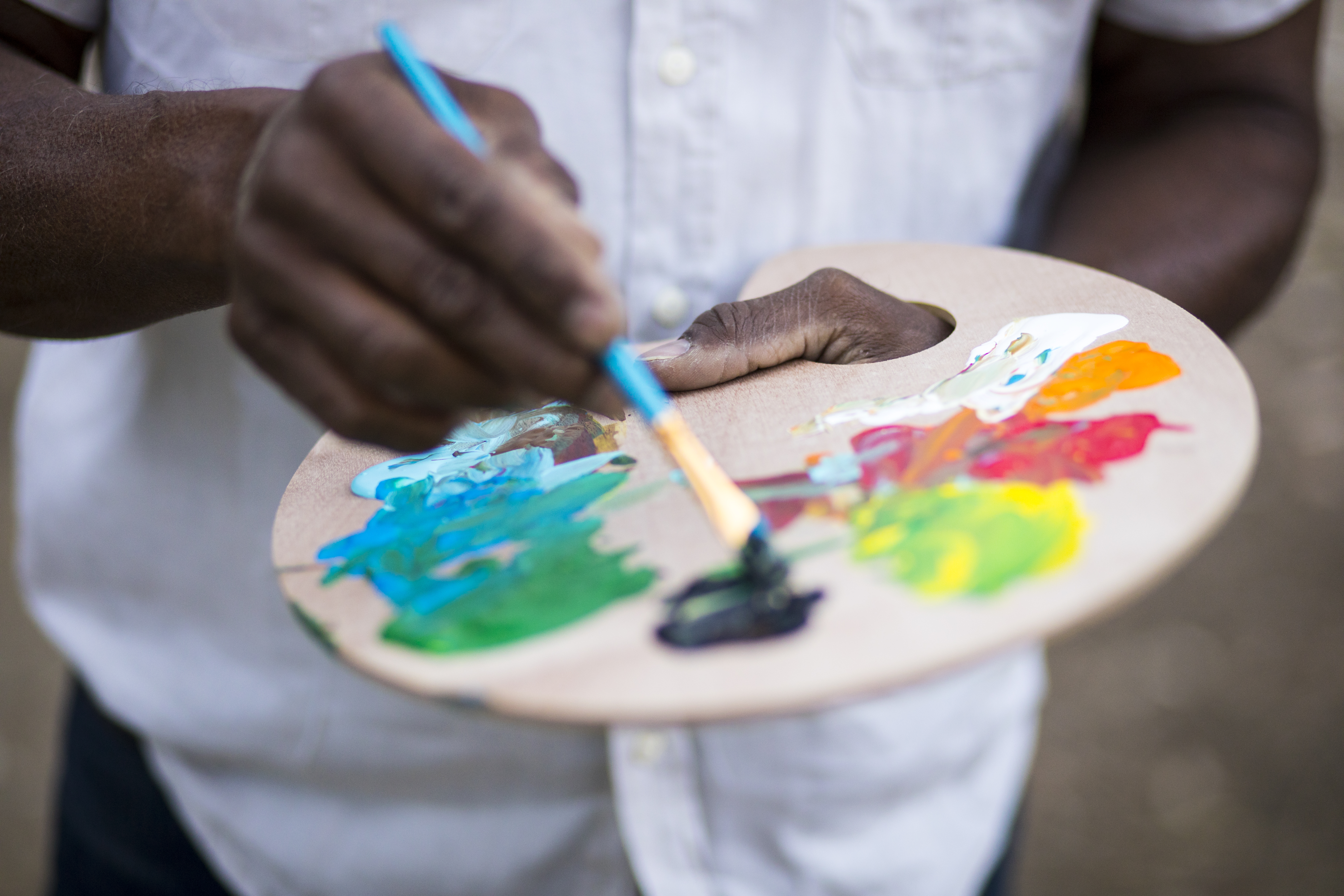 A retired black man painting