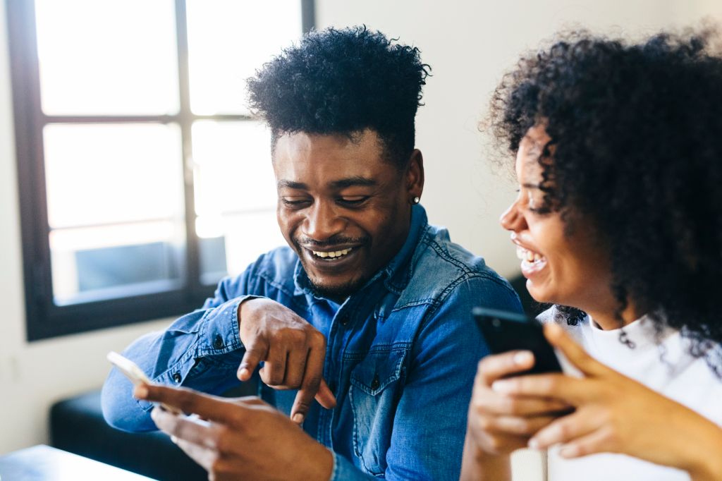 Happy couple looking at cell phone
