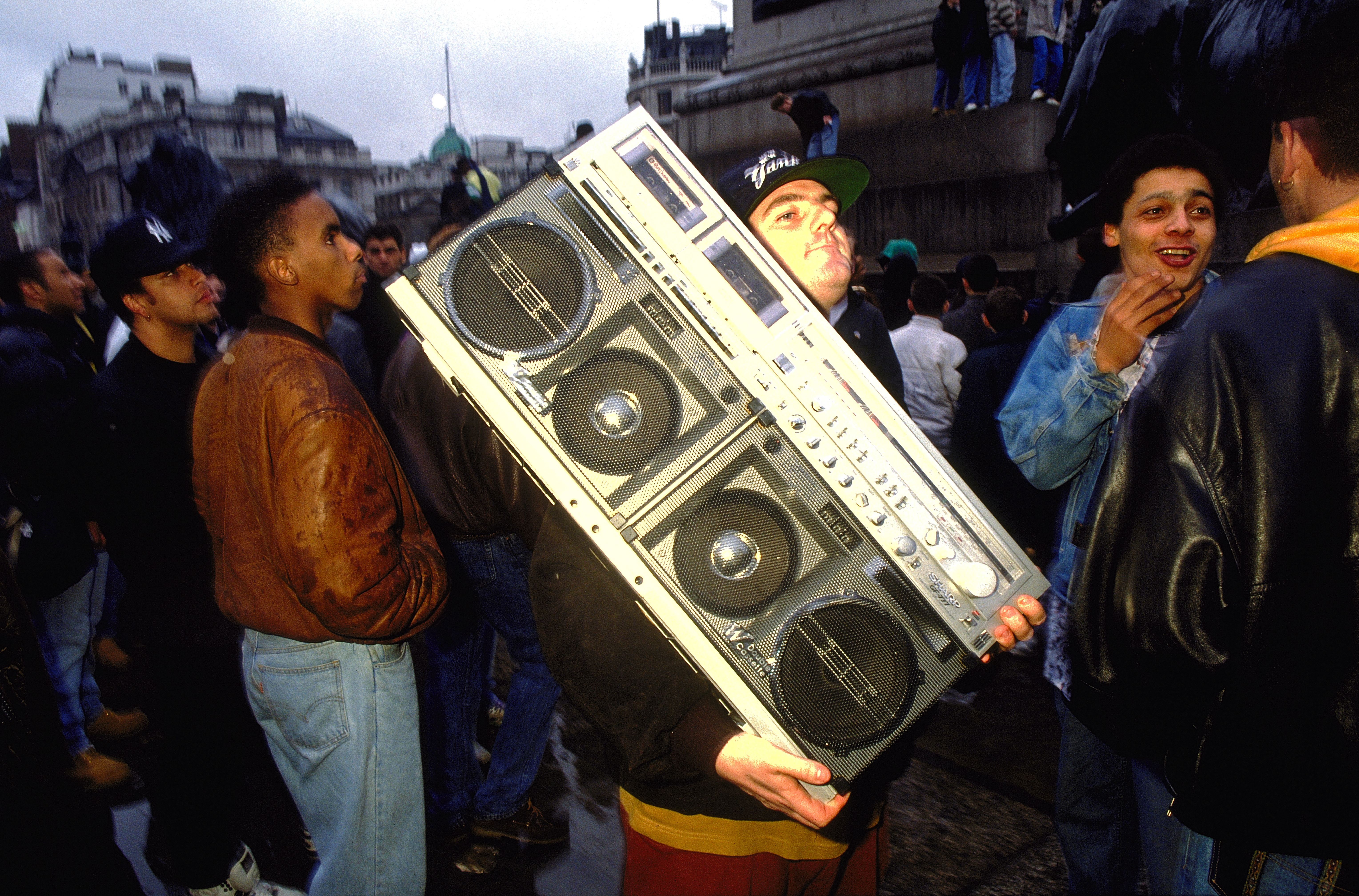 Protestor at 'Freedom to Party' demonstration carrying a just about portable tape deck Trafalgar Square London 1990