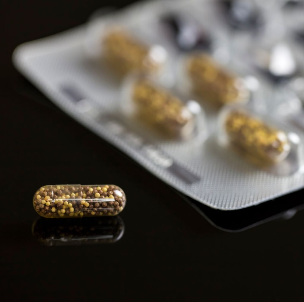 Transparent Capsule On black background. Medical concept