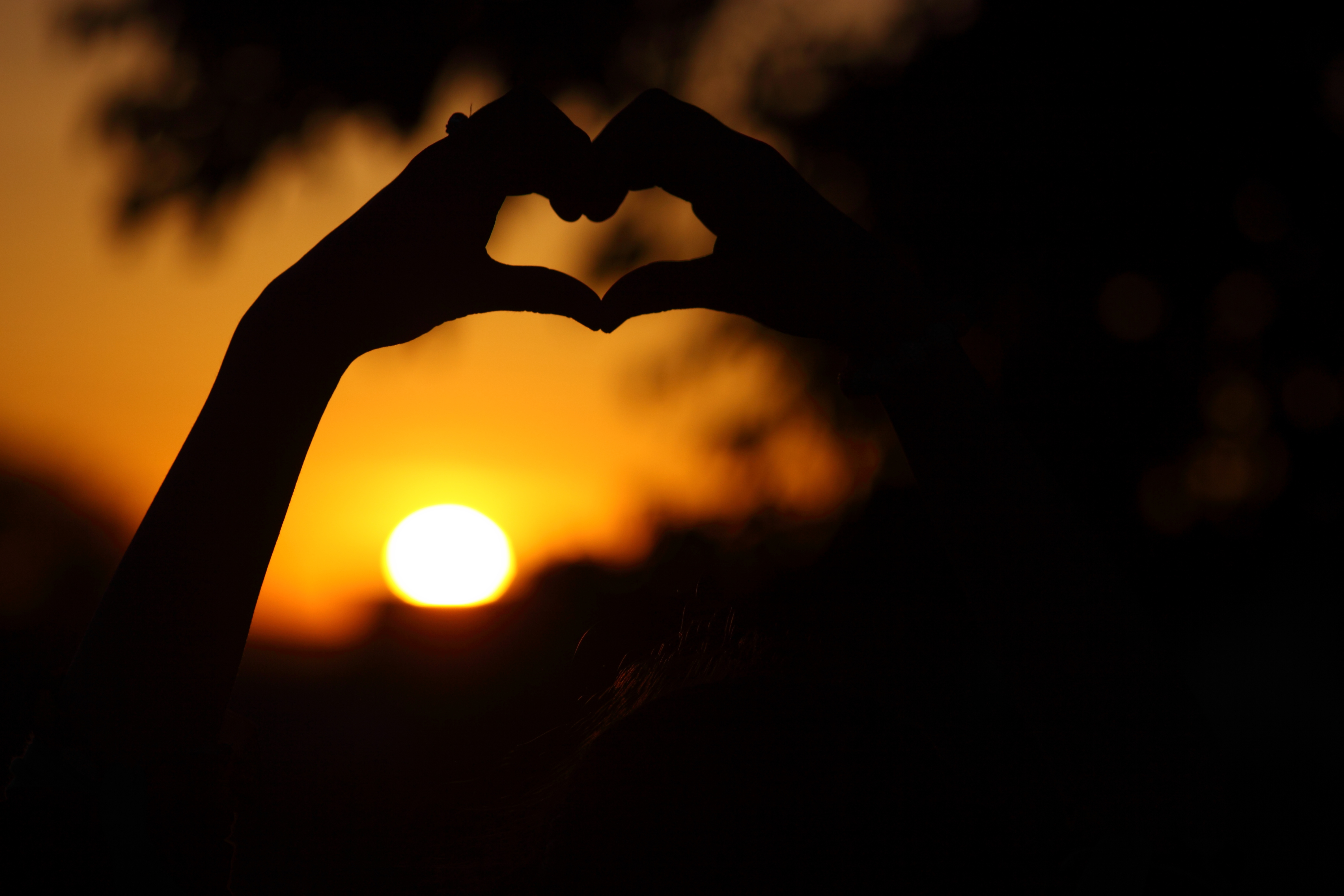 A girl making heart shape with both hands
