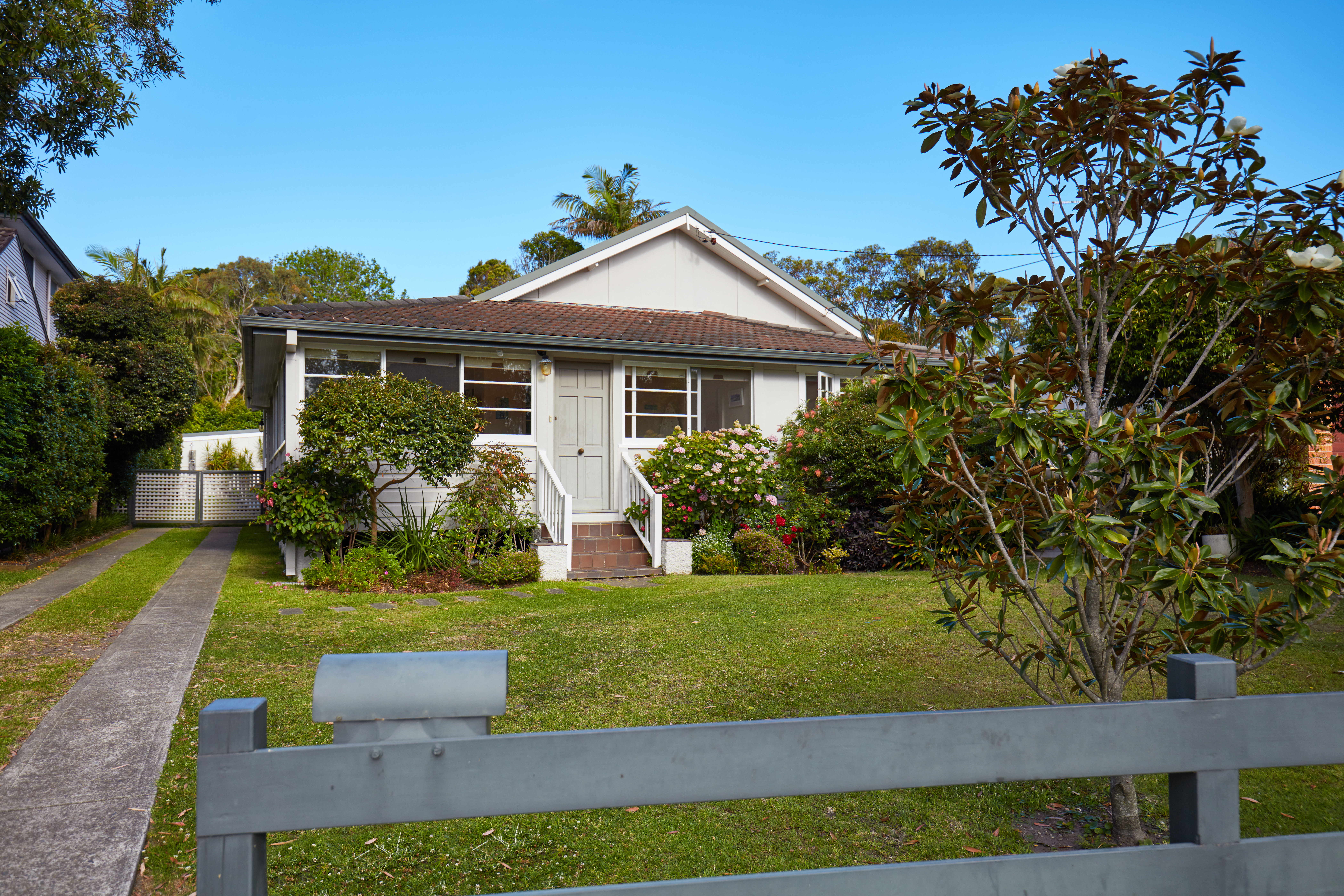 Australian house from fence in suburbs against sky
