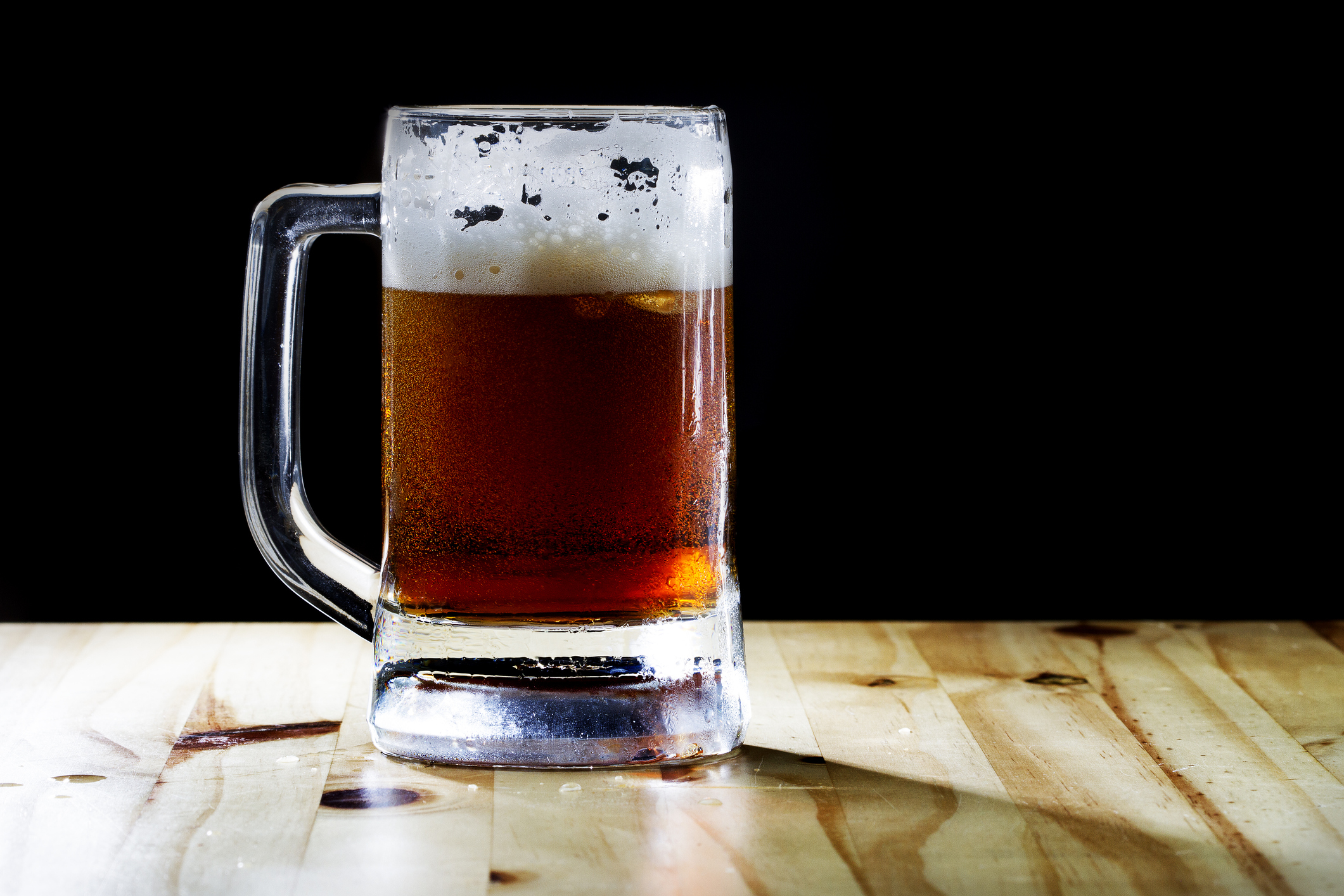 selective focus dark beer and foam with Beer mug and soft flare filter