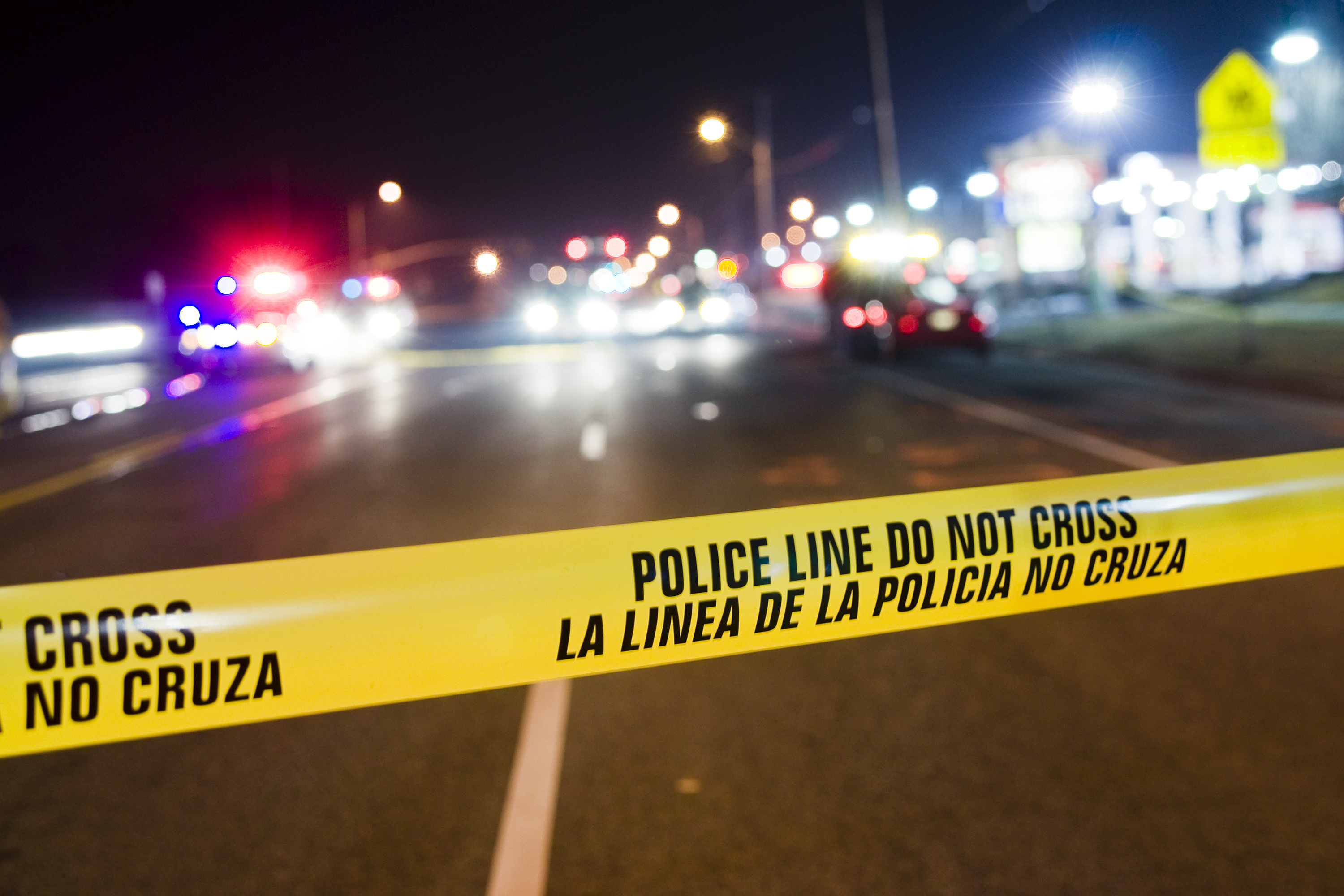 Yellow police line blocking off crime scene investigation