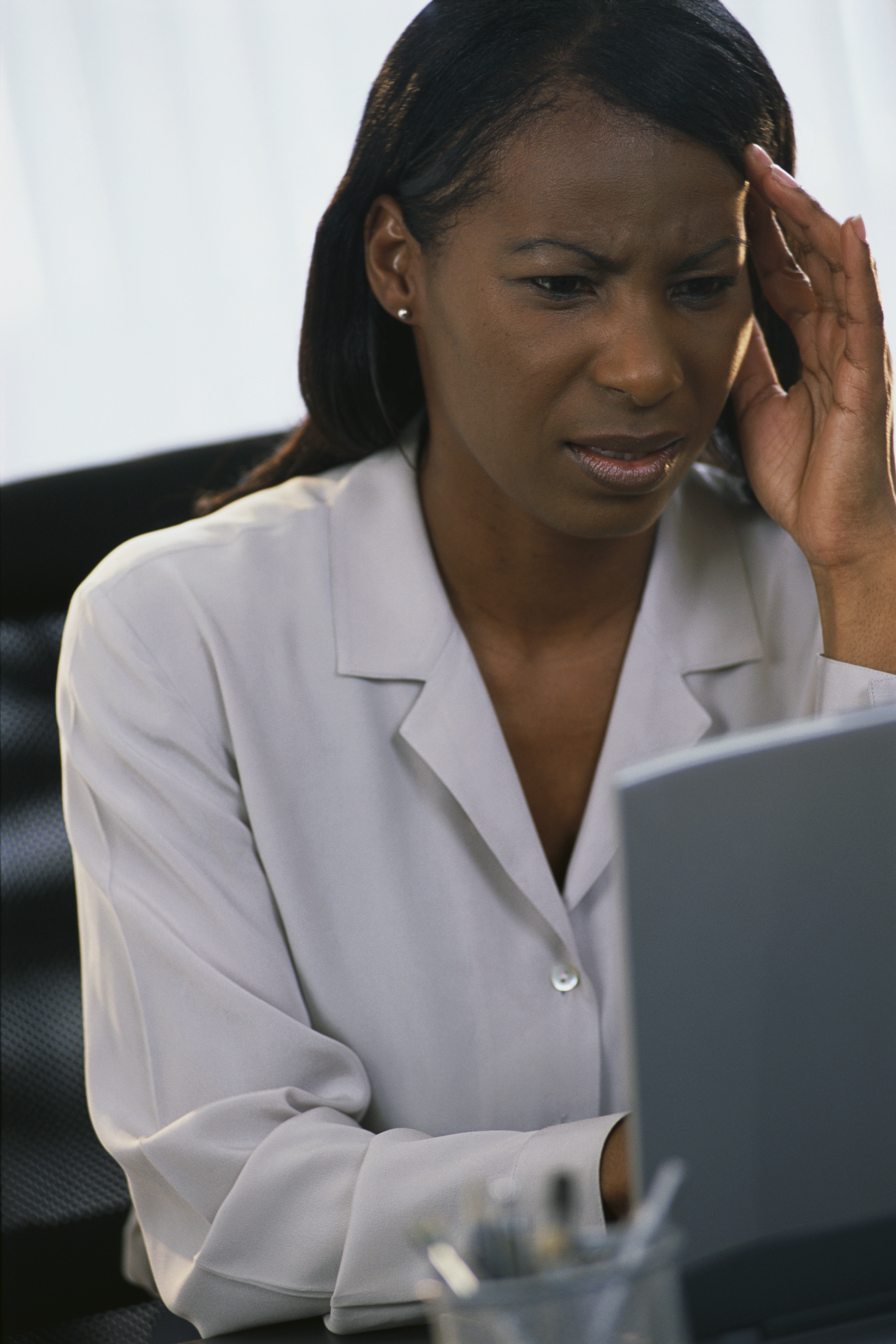 Confused Businesswoman Using Laptop