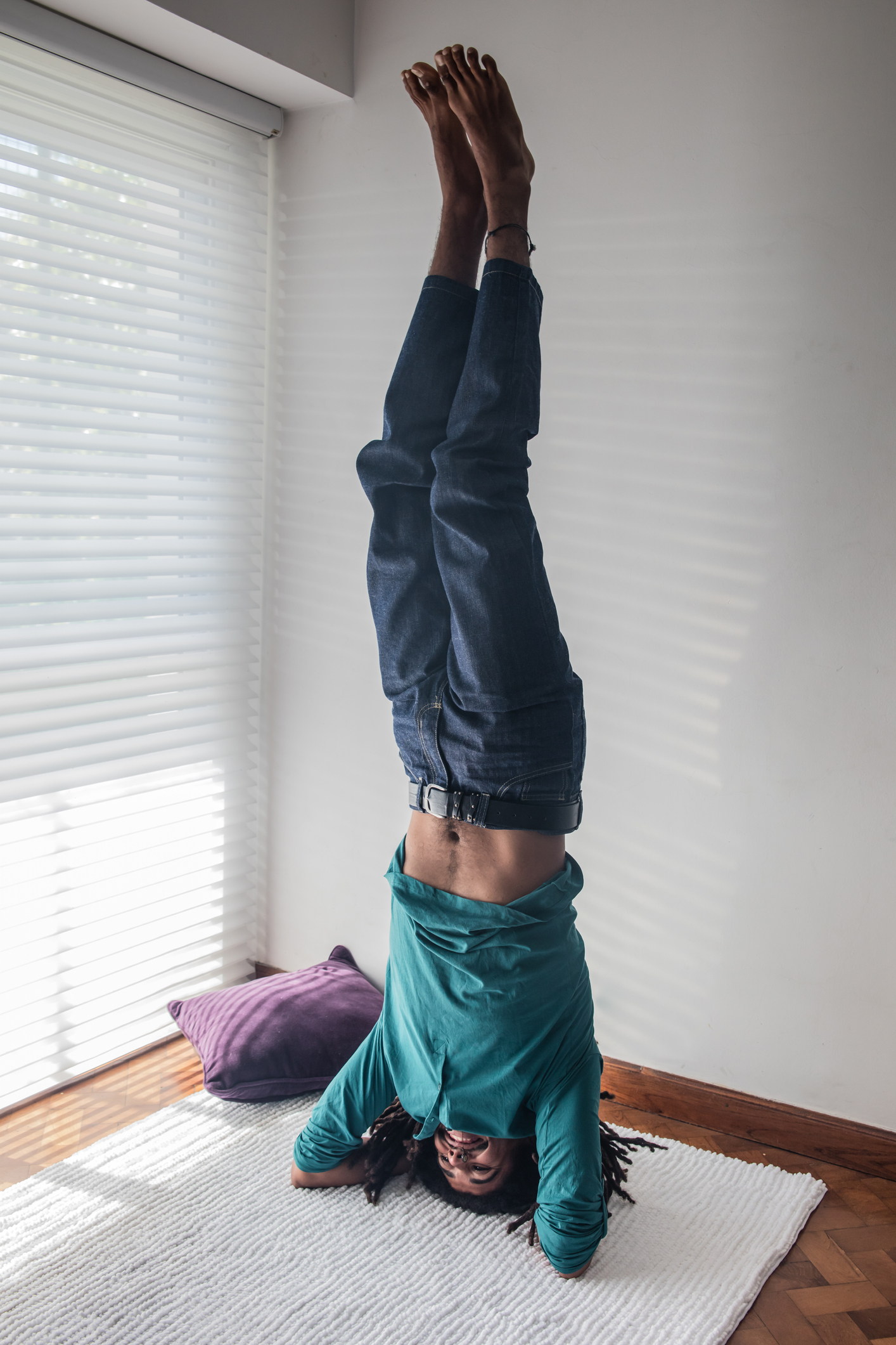 Happy relaxed rasta young man doing yoga