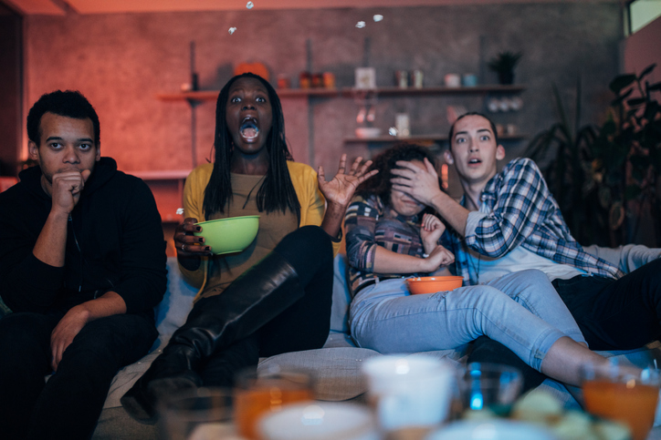Multi-ethnic friends watching TV
