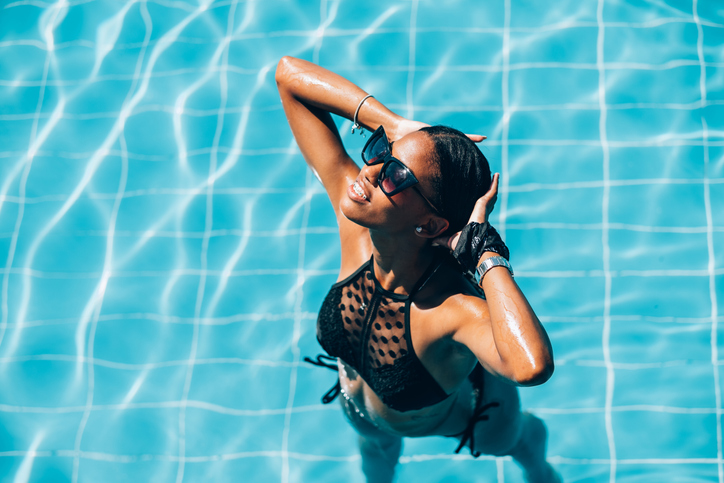 Young Black woman at resort pool
