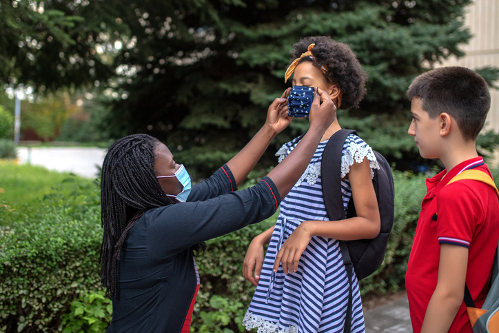 Mother and children on first school day