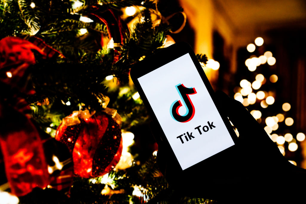 In this photo illustration a Tik Tok logo seen displayed on...