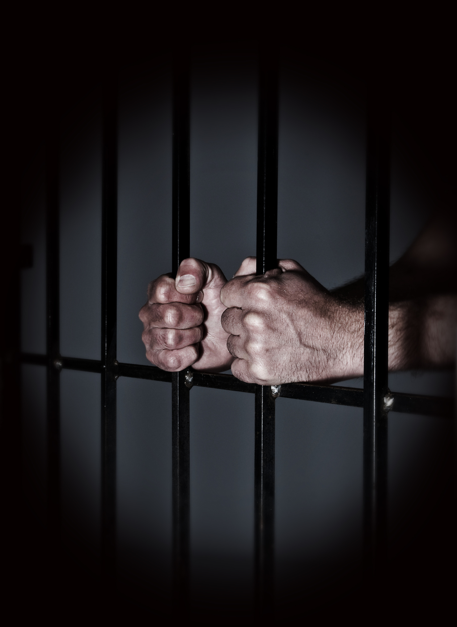 Prisoner behind prison bars