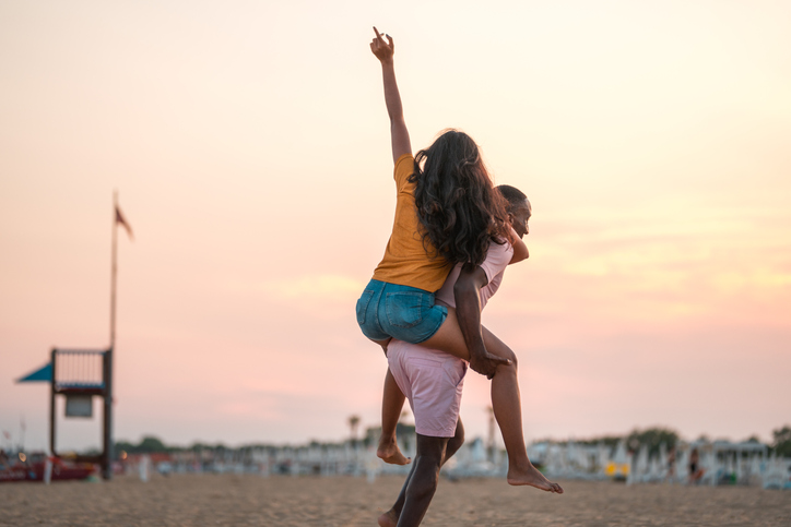 Romantic Multiracial Couple Playing at the Beach