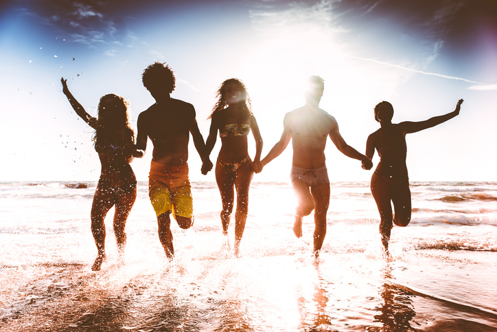Friends running on the beach
