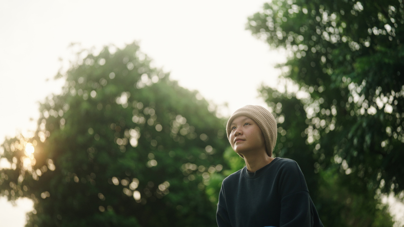 Teenager relaxing at park.
