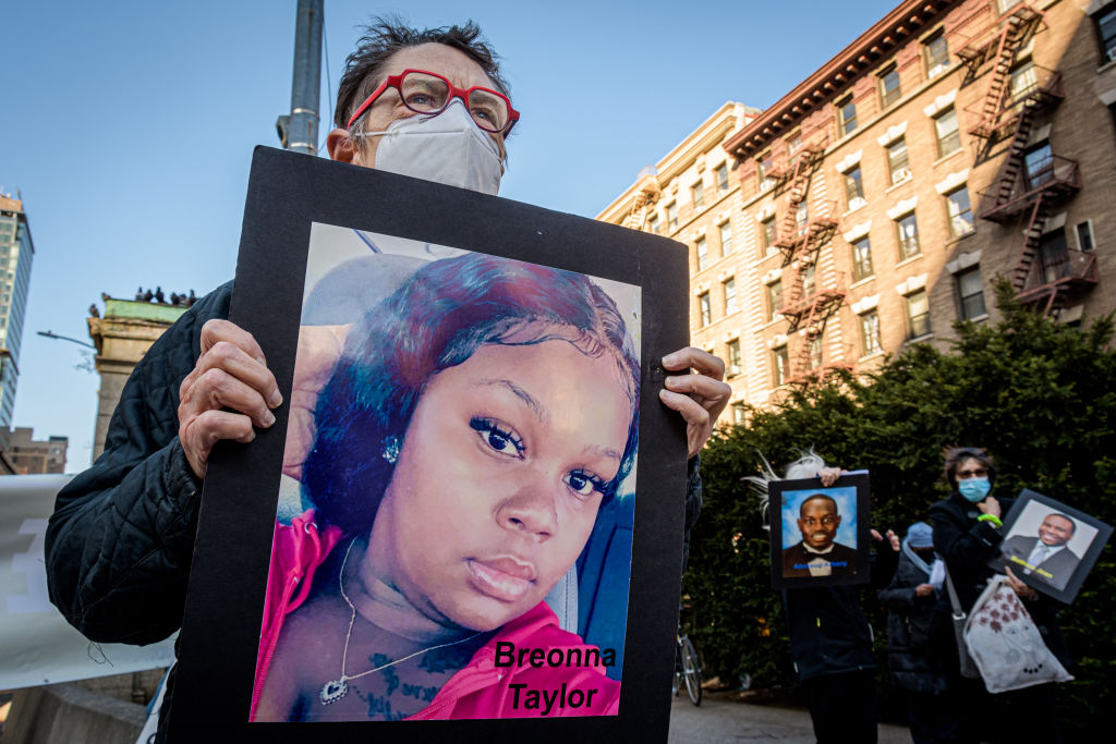 Participant seen holding a protrait of Breonna Taylor at the...