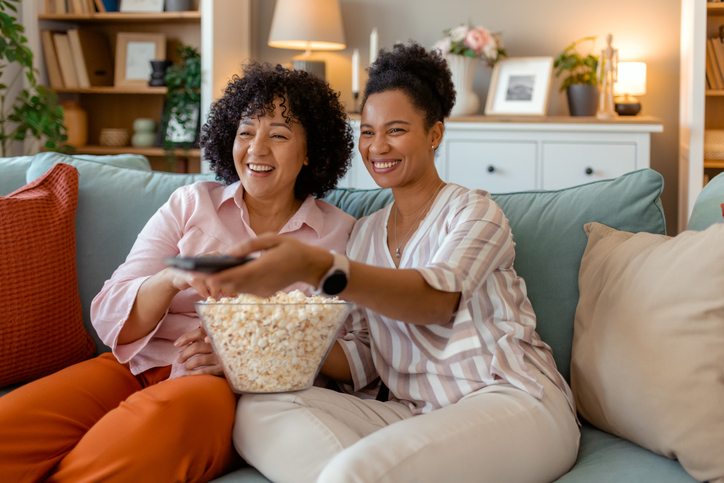 Best Friends Relaxing on the Couch with Popcorn and a Good Show