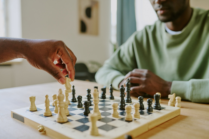 Unrecognizable Man Moving Knight Chess Piece